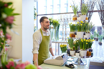 Image showing florist man or seller at flower shop counter