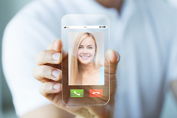 Image showing close up of hand with incoming call on smartphone