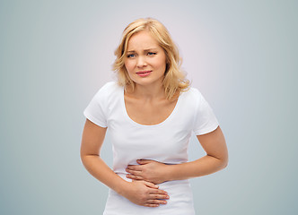 Image showing unhappy woman suffering from stomach ache