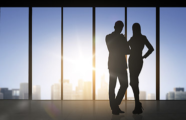 Image showing silhouettes of business partners over office