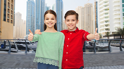 Image showing happy boy and girl showing thumbs up