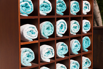 Image showing close up of shelf with rolled bath towels