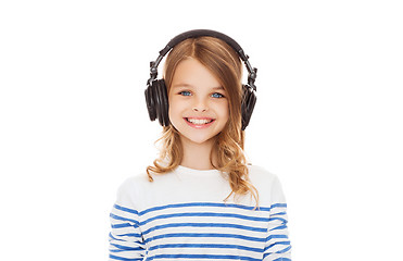 Image showing smiling girl with headphones listening to music