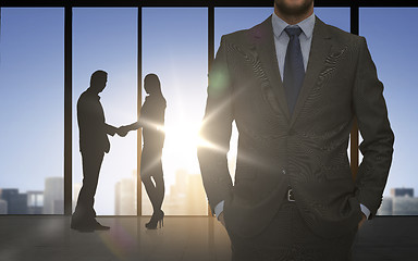Image showing business partners silhouettes shaking hands