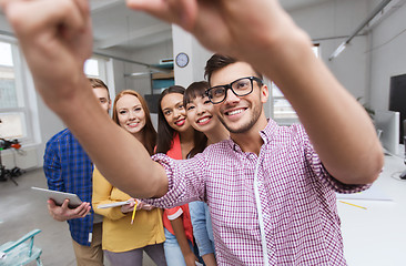 Image showing creative business team taking selfie at office