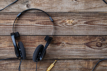 Image showing Headphones over wooden table.