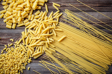 Image showing close up portrait of raw homemade italian pasta, macaroni, spaghetti, and fettuccine