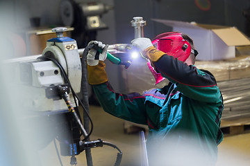 Image showing Industrial worker welding in metal factory.