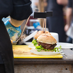 Image showing Beef burgers ready to serve on food stall.