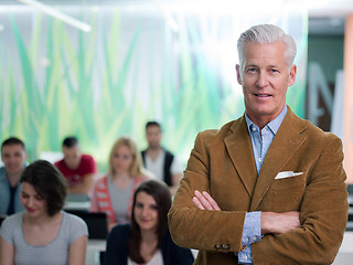 Image showing portrait of in teacher in classroom with students group in backg