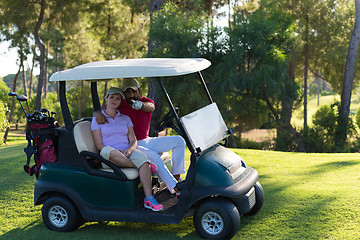 Image showing couple in buggy on golf course