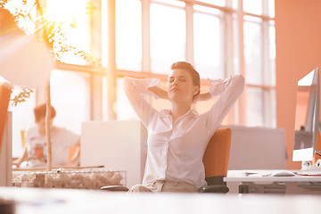 Image showing young business woman relaxing at workplace