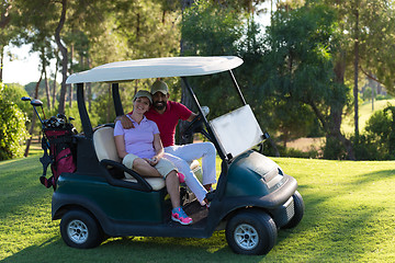 Image showing couple in buggy on golf course