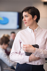 Image showing hispanic businesswoman with tablet at meeting room