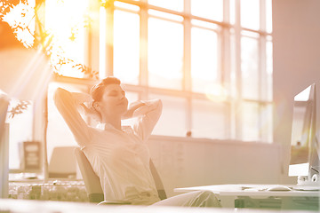 Image showing young business woman relaxing at workplace