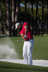 Image showing golfer hitting a sand bunker shot