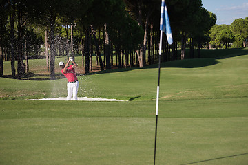 Image showing golfer hitting a sand bunker shot