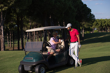 Image showing couple in buggy on golf course