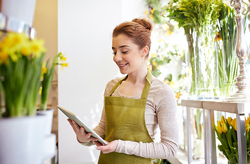 Image showing woman with tablet pc computer at flower shop