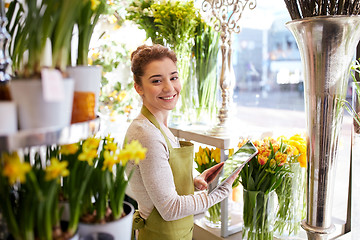 Image showing woman with tablet pc computer at flower shop