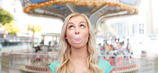 Image showing happy young woman or teenage girl chewing gum