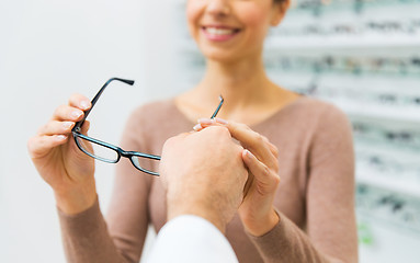 Image showing close up of woman with glasses at optics store