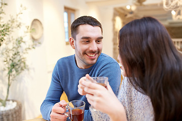 Image showing happy couple drinking tea at cafe