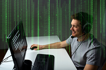 Image showing man in headset playing computer video game at home