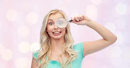 Image showing happy young woman with magnifying glass