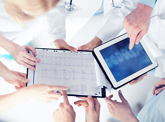 Image showing group of doctors looking at x-ray on tablet pc