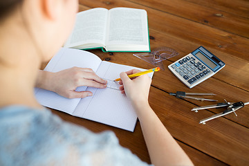 Image showing close up of hands with ruler and pencil drawing