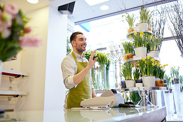 Image showing florist man or seller at flower shop counter