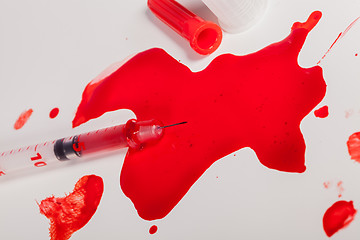 Image showing Syringe Squirting Red Blood onto White Background