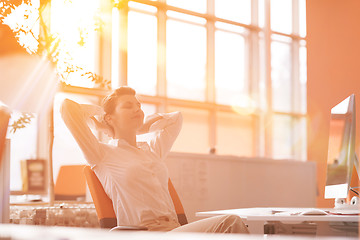 Image showing young business woman relaxing at workplace