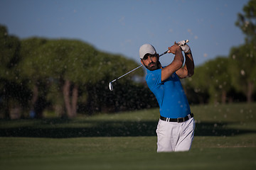 Image showing pro golfer hitting a sand bunker shot