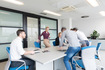 Image showing business people group entering meeting room, motion blur