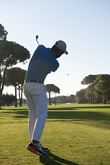 Image showing golf player hitting shot