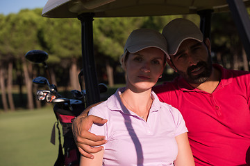 Image showing couple in buggy on golf course