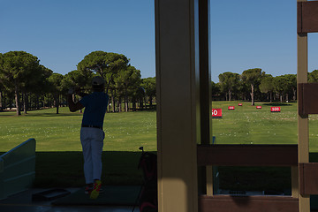 Image showing golf player practicing shot on training