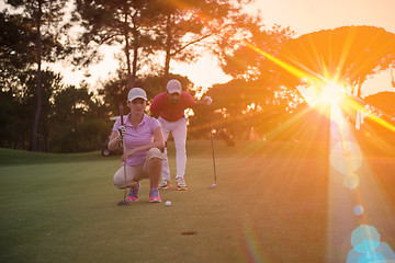 Image showing couple on golf course at sunset