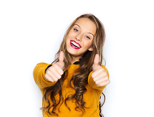 Image showing happy young woman or teen girl showing thumbs up