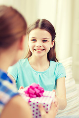 Image showing happy little girls with birthday present at home