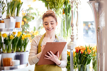 Image showing florist woman with clipboard at flower shop