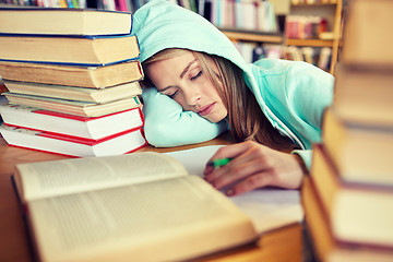 Image showing student or woman with books sleeping in library