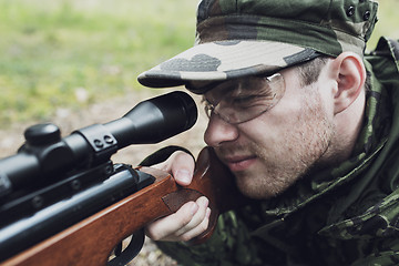 Image showing close up of soldier or hunter with gun in forest