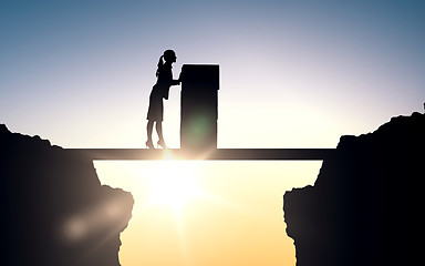 Image showing silhouette of businesswoman moving boxes at office