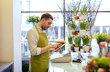 Image showing man with tablet pc computer at flower shop