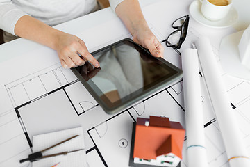 Image showing close up of hand with blueprint and tablet pc