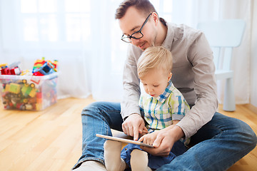 Image showing father and son with tablet pc playing at home