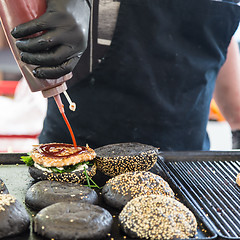 Image showing Beef burgers ready to serve on food stall.